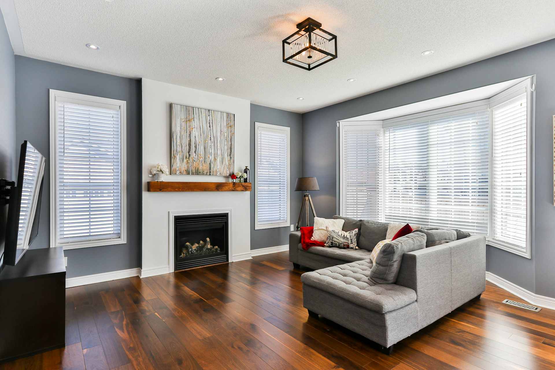 Freshly decorated living room with feature fireplace and hardwood flooring